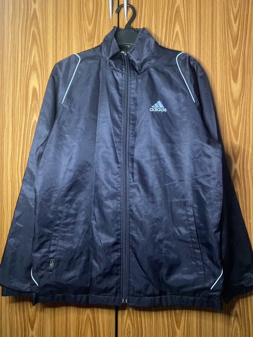 Adidas Navy Blue Windbreaker (Category: Coats, Jackets and Outerwear) located in Calamba. Submitted by gdeclutters_ (Listing ID 1467301273, Image 1). Description: - Brand: Adidas - Color: Navy blue with soft grey fleece lining - Fit: Standard fit with classic three stripes - Material: Polyester blend (check tags for wash care) - Origin: Made in Japan - Condition: Excellent, ready to wear.