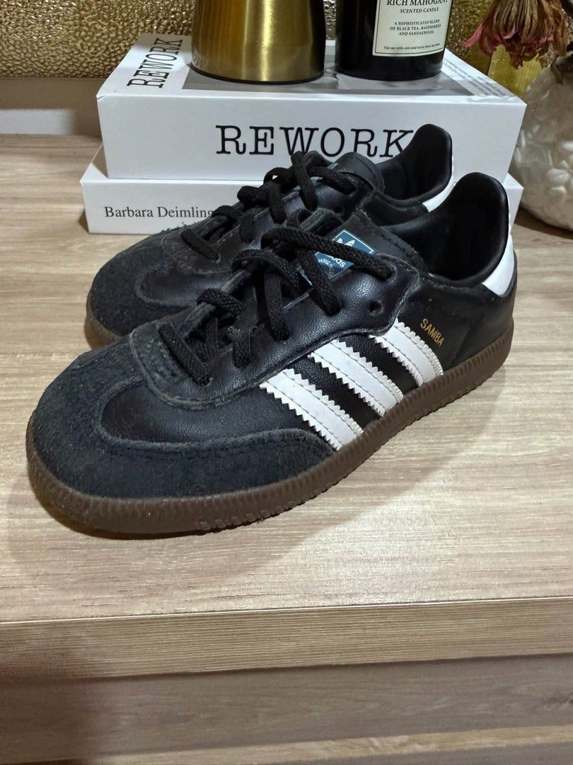 Adidas Samba Black White Gum Sole (Category: Babies & Kids Fashion) located in Lapu Lapu. Submitted by mailicious38743 (Listing ID 1467361237, Image 1). Description: Classic Adidas Samba sneakers in black leather with white stripes and iconic gum soles. Suede toe caps, black laces, gold lettering on the side. Timeless court style, goes with pretty much any casual outfit. Normal signs of wear on the suede and soles. Size: US-9 1/2 UK-9 Fr-26 1/2.