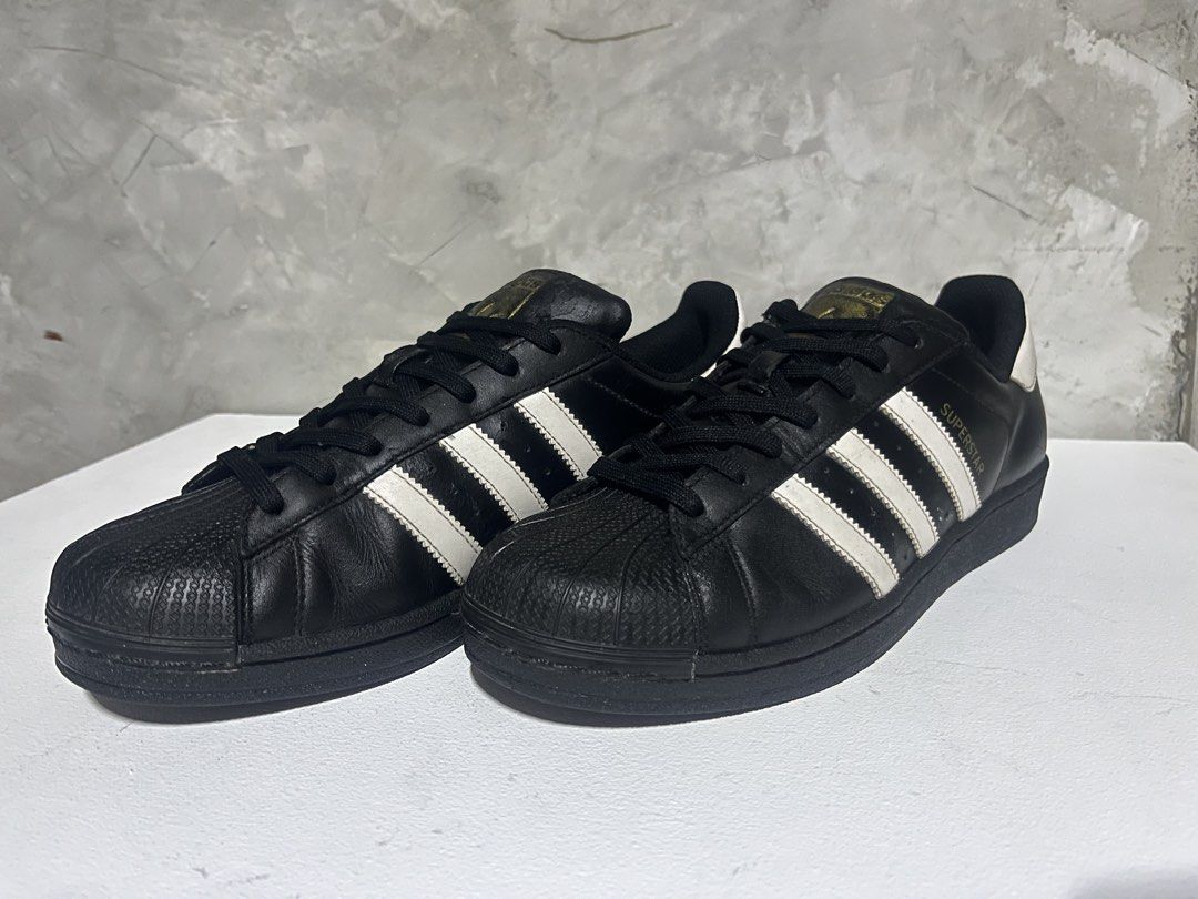 Adidas Superstar Black White Shell Toe Sneakers (Category: Shoe inserts & accessories) located in Manila. Submitted by silentwater_f64808 (Listing ID 1467300361, Image 2). Description: - Brand: Adidas Superstar - Color: Black and white - Material: Premium leather upper with classic rubber shell toe - Details: Signature 3-stripes on the side and gold branding on the tongue - Sole: Durable rubber outsole with herringbone traction pattern - Style: I