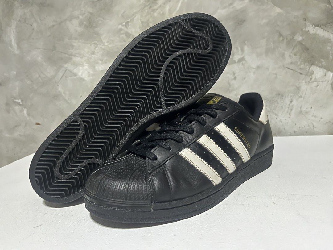 Adidas Superstar Black White Shell Toe Sneakers (Category: Shoe inserts & accessories) located in Manila. Submitted by silentwater_f64808 (Listing ID 1467300361, Image 1). Description: - Brand: Adidas Superstar - Color: Black and white - Material: Premium leather upper with classic rubber shell toe - Details: Signature 3-stripes on the side and gold branding on the tongue - Sole: Durable rubber outsole with herringbone traction pattern - Style: I