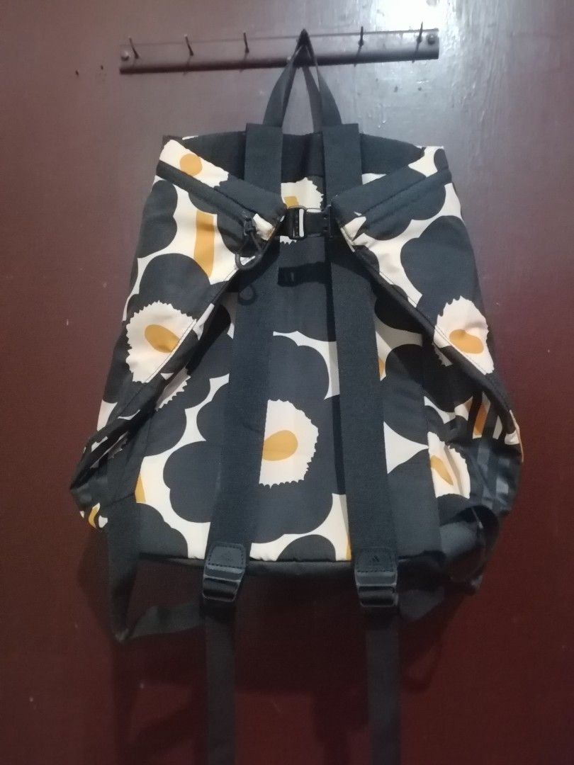 Adidas x Marimekko Print Backpack (Category: Backpacks) located in Manila. Submitted by alden_apparel (Listing ID 1467257059, Image 3). Description: - Authentic Adidas x Marimekko collaboration backpack - Eye-catching yellow, black, and beige flower print - Secure zip top closure with an adjustable back buckle strap - Comfortable dual shoulder straps and a convenient top handle - Co-branded logo patch on the front lower corner - Roomy main compar