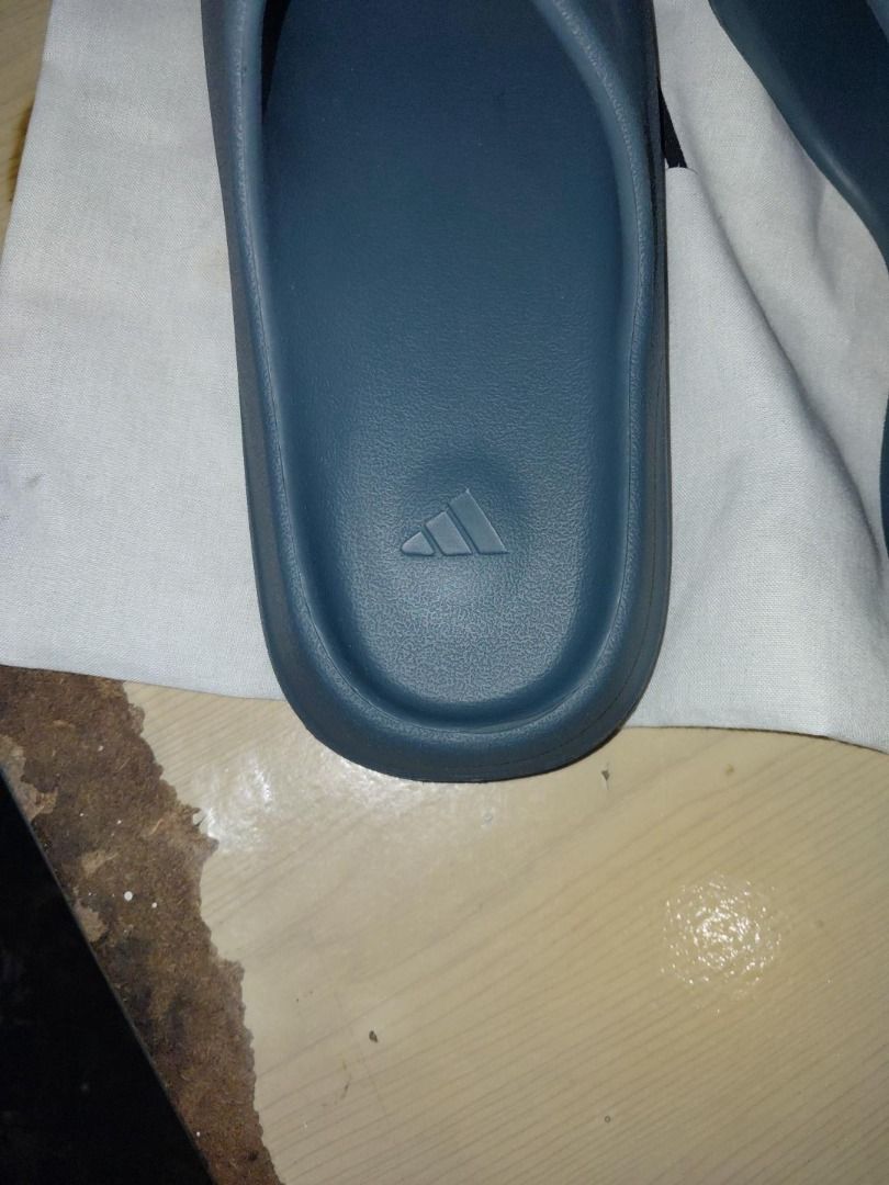 Adidas Yeezy Slides Slate Marine (Category: Slippers & Slides) located in Manila. Submitted by cosmicturtle.d1b615 (Listing ID 1464864394, Image 2). Description: - Model: Adidas Yeezy Slides - Colorway: Slate Marine - Design: Minimalist slip-on with a clean aesthetic - Comfort: Molded footbed for maximum, all-day cushioning - Traction: Chunky sawtooth sole for extra grip - Details: Iconic Adidas trefoil logo debossed on the heel bed - Usage: Vers