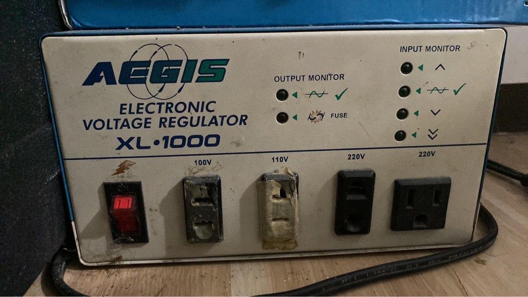 Aegis XL-1000 Electronic Voltage Regulator (Category: Electrical, Adaptors & Sockets) located in Manila. Submitted by boldfire_5aad05 (Listing ID 1467344014, Image 1). Description: - Brand/Model: Aegis XL-1000 Electronic Voltage Regulator - Power Support: Multiple outlets for 100V, 110V, and 220V configurations - Controls & Indicators: Front panel on/off switch with input monitor status lights and output monitoring indicators - Included: Glass fu