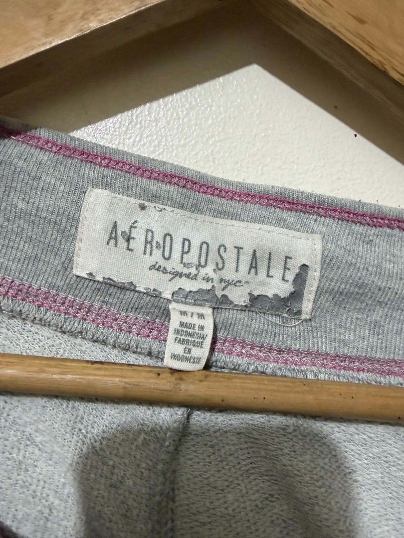 Aeropostale Grey NYC Sweatpants (Category: Joggers) located in Caloocan City. Submitted by Tulokss (Listing ID 1467276171, Image 2). Description: - Brand: Aeropostale - Size: M - Color: Grey with pink and white accents - Design: Large embroidered NYC Aero graphic on the left leg - Features: Drawstring waistband with branded metal eyelets, pink contrast stitching, and cuffed ankles - Material: Soft cotton blend - Condition: Great for cozy lounging