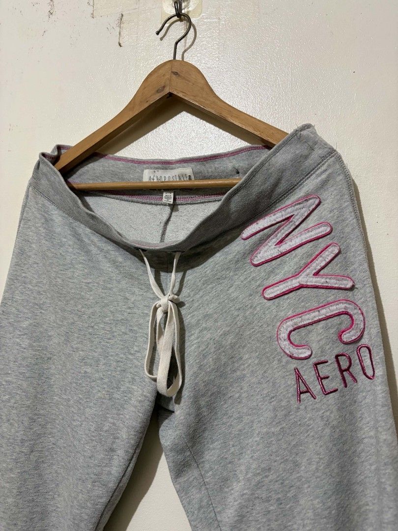 Aeropostale Grey NYC Sweatpants (Category: Joggers) located in Caloocan City. Submitted by Tulokss (Listing ID 1467276171, Image 1). Description: - Brand: Aeropostale - Size: M - Color: Grey with pink and white accents - Design: Large embroidered NYC Aero graphic on the left leg - Features: Drawstring waistband with branded metal eyelets, pink contrast stitching, and cuffed ankles - Material: Soft cotton blend - Condition: Great for cozy lounging