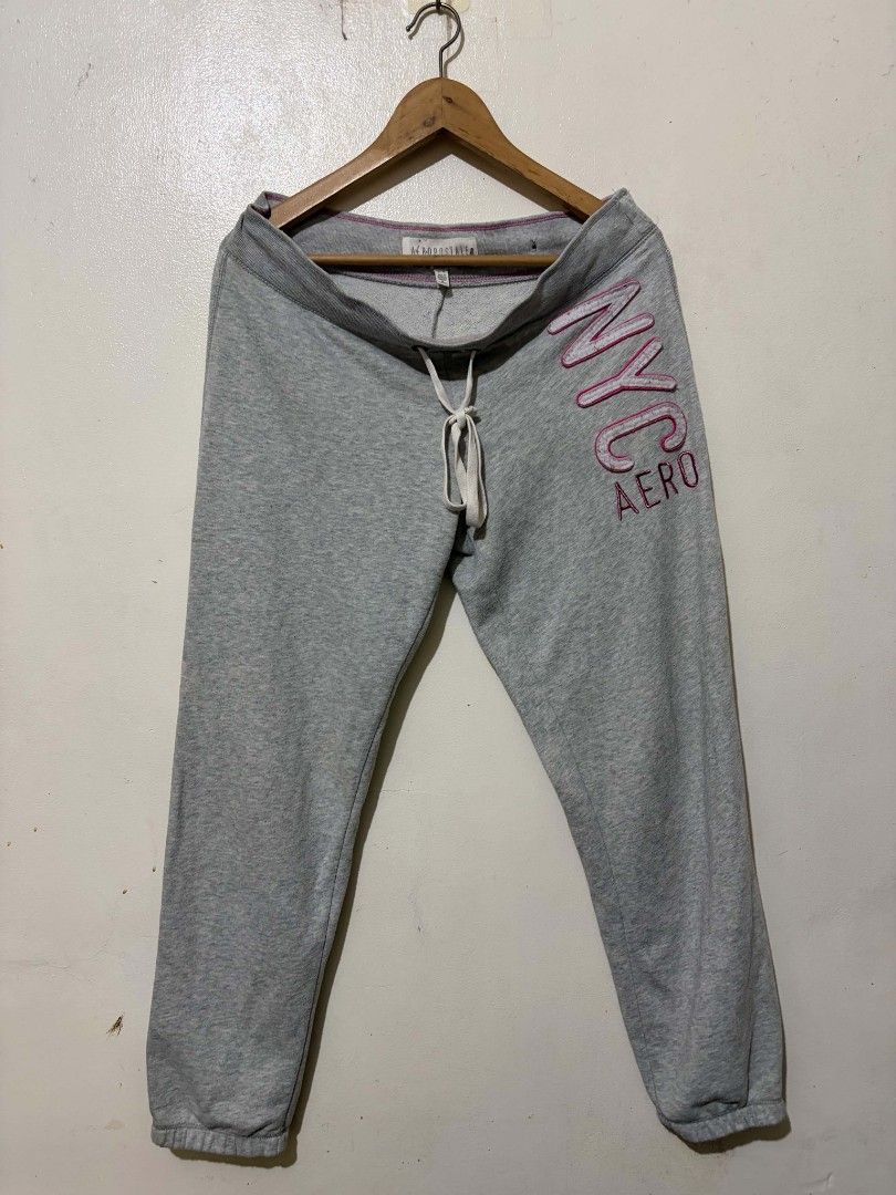 Aeropostale Grey NYC Sweatpants (Category: Joggers) located in Caloocan City. Submitted by Tulokss (Listing ID 1467276171, Image 3). Description: - Brand: Aeropostale - Size: M - Color: Grey with pink and white accents - Design: Large embroidered NYC Aero graphic on the left leg - Features: Drawstring waistband with branded metal eyelets, pink contrast stitching, and cuffed ankles - Material: Soft cotton blend - Condition: Great for cozy lounging