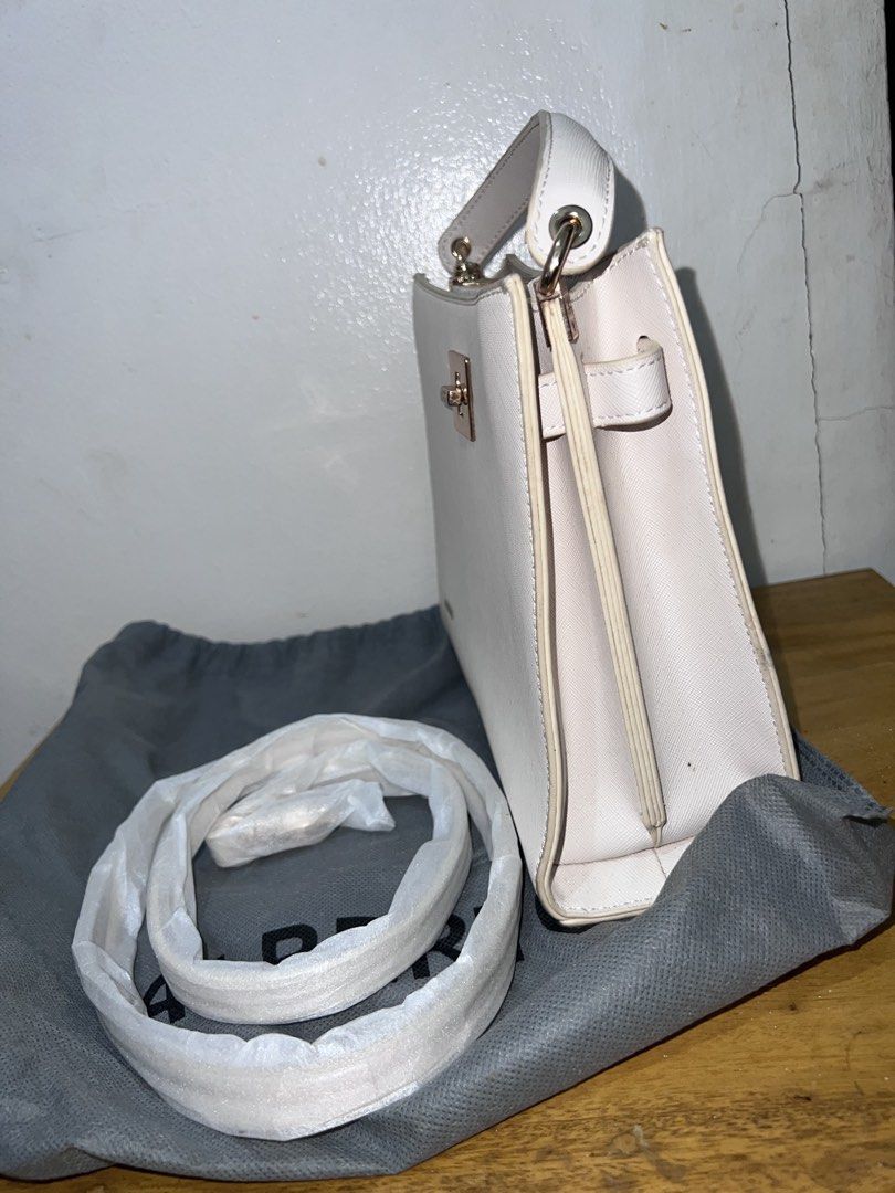ALBERTO White Structured Handbag with Strap (Category: Luxury Bags & Wallets) located in Manila. Submitted by goldenwater_a772ad (Listing ID 1467271167, Image 2). Description: - Brand: ALBERTO - Color: Classic White - Hardware: Elegant gold-tone closure - Interior: Double main compartments with a secure zipped center pocket - Included: Matching adjustable shoulder strap (still wrapped in protective packaging) and original grey dust bag - Conditio