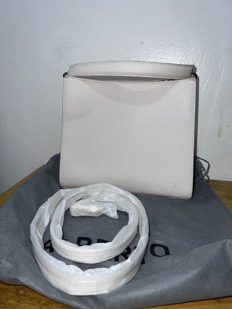 ALBERTO White Structured Handbag with Strap (Category: Luxury Bags & Wallets) located in Manila. Submitted by goldenwater_a772ad (Listing ID 1467271167, Image 3). Description: - Brand: ALBERTO - Color: Classic White - Hardware: Elegant gold-tone closure - Interior: Double main compartments with a secure zipped center pocket - Included: Matching adjustable shoulder strap (still wrapped in protective packaging) and original grey dust bag - Conditio