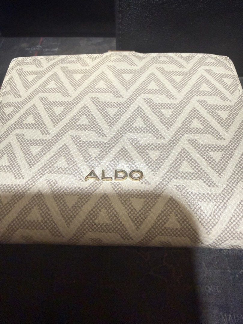 ALDO Women's Wallet Bundle Set (3 Wallets) (Category: Wallets & Card holders) located in Opol. Submitted by great_finds_kollexion (Listing ID 1467173330, Image 2). Description: - Brand: ALDO - Quantity: Set of 3 wallets - Colors: Black and beige - Includes: 1 beige geometric foldover wallet, 1 black smooth textured wallet with gold hardware, and 1 black compact zippered wallet with ALDO logo plaque - Condition: Excellent - Perfect for everyday us