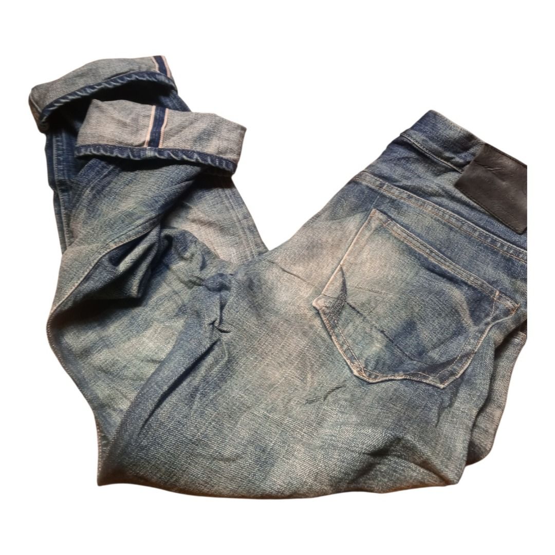 AllSaints Spit Alfields Denim Jeans Size 32 (Category: Jeans) located in Caloocan City. Submitted by goldendragon_b05555 (Listing ID 1467361953, Image 2). Description: - Brand: AllSaints (Spit Spitalfields) - Size: 32 - Fit: Straight leg - Wash: Classic blue with natural fading on thighs and seat - Details: Distressed styling, button fly, and cuffed hems with visible selvedge ID - Branding: Black leather back patch and interior branded fabric lab