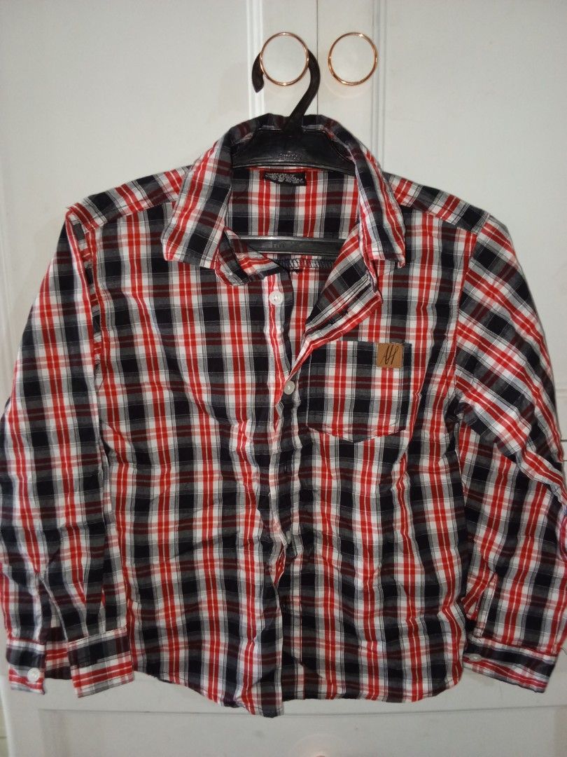 American Hawk Red Black Plaid Long Sleeve Button Down Shirt (Category: Babies & Kids Fashion) located in Trece Martires City. Submitted by lotlotonlineshop (Listing ID 1467336533, Image 1). Description: - Brand: American Hawk - Style: Long sleeve button-down shirt with standard collar - Pattern: Classic red, black, and white plaid - Details: Single chest pocket with small brown logo patch, button cuffs - Material: 60% cotton, 40% polyester (machi