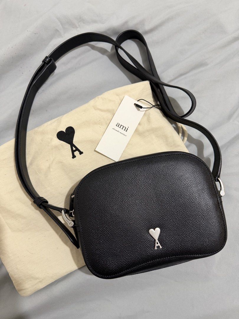 Ami Paris Black Leather Camera Bag (Category: Cross-body Bags) located in Lipa City. Submitted by eunicemndrgn (Listing ID 1467210149, Image 1). Description: - Brand: Ami Alexandre Mattiussi - Material: Premium black pebbled leather with clean textured grain finish - Hardware: Silver-tone with signature heart logo plaque on the front - Strap: Adjustable crossbody strap for comfortable wear - Size: Compact everyday size - Inclusions: Original dust