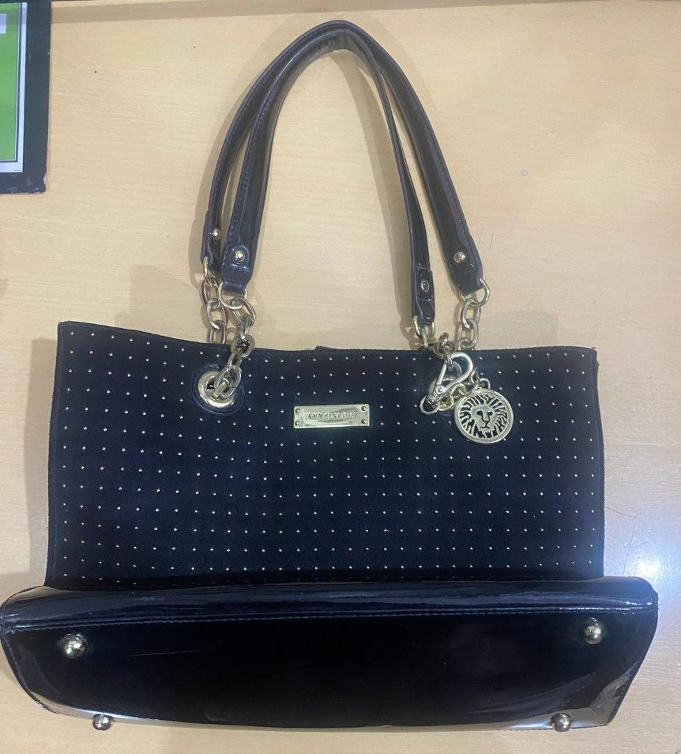 Anne Klein Black Studded Tote Bag (Category: Tote Bags) located in Manila. Submitted by lovelypreloved1497 (Listing ID 1467282052, Image 1). Description: - Brand: Anne Klein - Color: Black - Material: Suede body with tiny gold studs and shiny patent bottom trim - Hardware: Gold-tone front plate and matching lion logo charm on the chain strap - Interior: Playful polka dot fabric lining with convenient zip compartments - Condition: Brand new with M