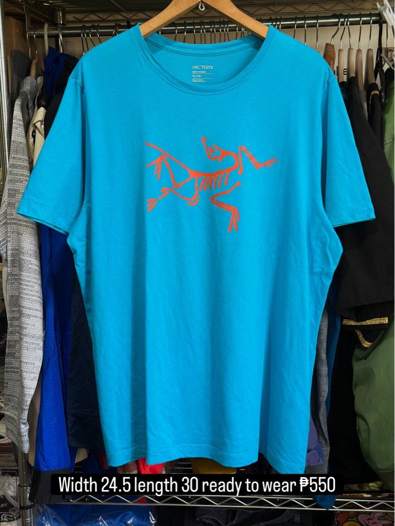 Arc'teryx Blue T-Shirt Size XL (Category: Tshirts & Polo Shirts ) located in Daet. Submitted by thrifthings2018 (Listing ID 1467244321, Image 1). Description: Bright blue Arc'teryx t-shirt with large orange bird logo on the front. Size XL for men. Made from 100% cotton in Vietnam. Tag specifies do not use fabric softener. Crew neck style, clean solid blue back..
