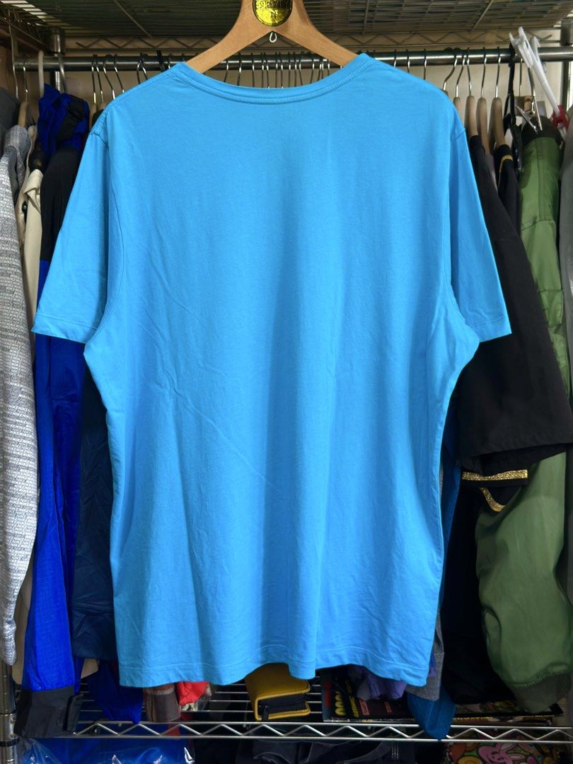 Arc'teryx Blue T-Shirt Size XL (Category: Tshirts & Polo Shirts ) located in Daet. Submitted by thrifthings2018 (Listing ID 1467244321, Image 3). Description: Bright blue Arc'teryx t-shirt with large orange bird logo on the front. Size XL for men. Made from 100% cotton in Vietnam. Tag specifies do not use fabric softener. Crew neck style, clean solid blue back..