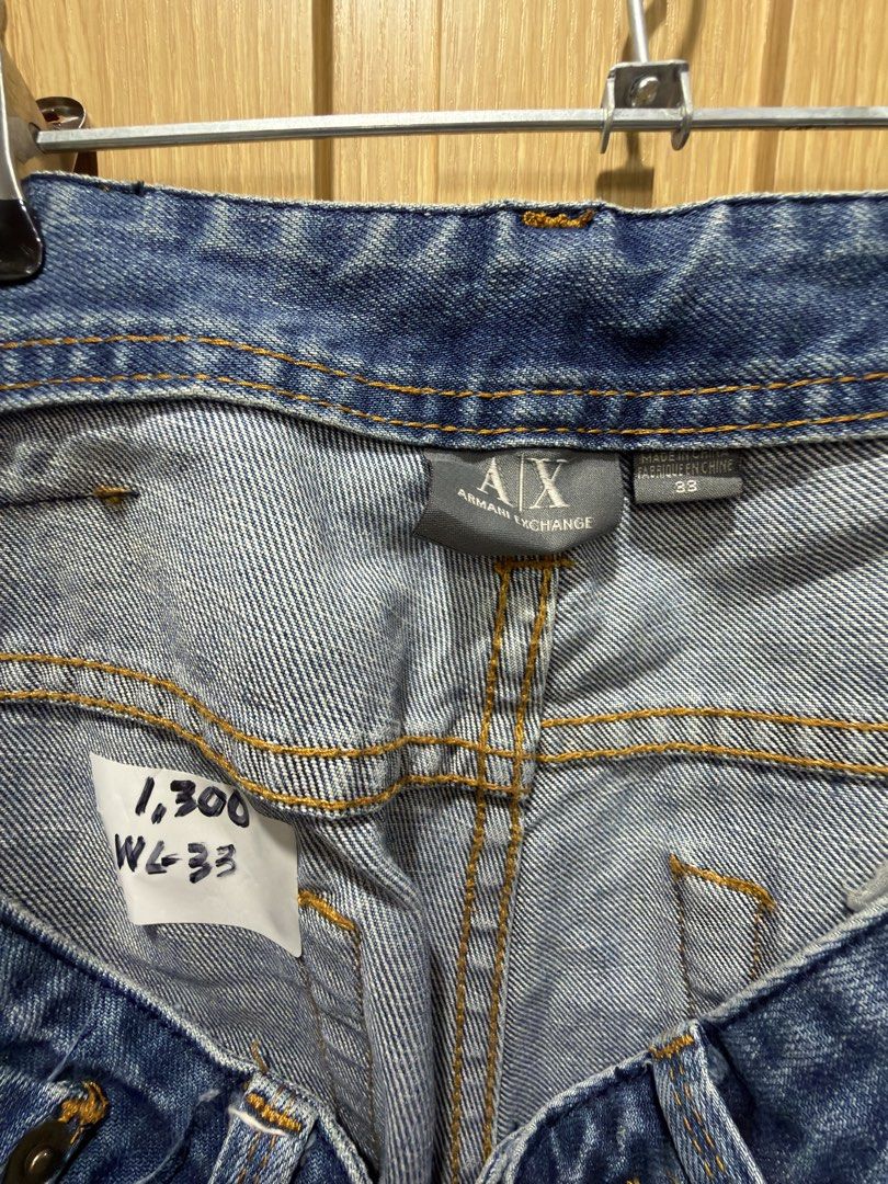 Armani Exchange Distressed Blue Jeans Size 33 (Category: Jeans) located in Bacoor. Submitted by preloved_with_love_ (Listing ID 1467333046, Image 3). Description: - Brand: Armani Exchange - Style: Distressed denim jeans with medium blue wash - Size: 33 waist - Details: Factory whiskering, subtle front distressing, classic 5-pocket styling, and branded rear leather patch - Material: Structured, durable fabric with strong stitching - Origin: Made i
