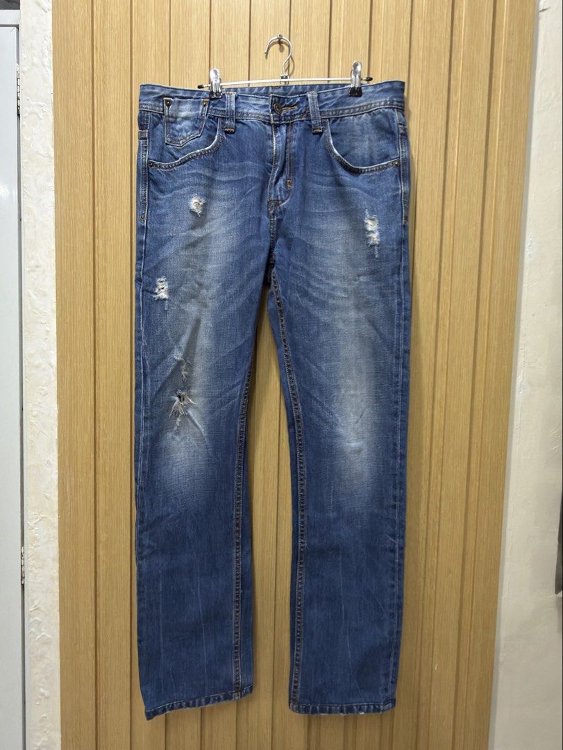 Armani Exchange Distressed Blue Jeans Size 33 (Category: Jeans) located in Bacoor. Submitted by preloved_with_love_ (Listing ID 1467333046, Image 1). Description: - Brand: Armani Exchange - Style: Distressed denim jeans with medium blue wash - Size: 33 waist - Details: Factory whiskering, subtle front distressing, classic 5-pocket styling, and branded rear leather patch - Material: Structured, durable fabric with strong stitching - Origin: Made i