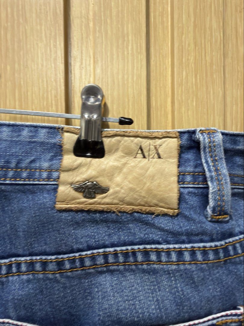 Armani Exchange Distressed Blue Jeans Size 33 (Category: Jeans) located in Bacoor. Submitted by preloved_with_love_ (Listing ID 1467333046, Image 2). Description: - Brand: Armani Exchange - Style: Distressed denim jeans with medium blue wash - Size: 33 waist - Details: Factory whiskering, subtle front distressing, classic 5-pocket styling, and branded rear leather patch - Material: Structured, durable fabric with strong stitching - Origin: Made i