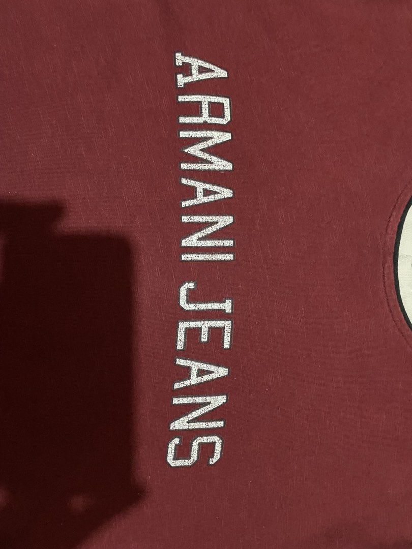 Armani Jeans Ringer TShirt (With Flaw MUST READ) (Category: Luxury Apparel) located in Marilao. Submitted by clear_out_closet (Listing ID 1467173849, Image 2). Description: Item Details: 👇 • Brand: Armani Jeans (AJ) • Color: Maroon / Burgundy with off-white contrast ringer trim • Material: 100% Cotton (heavyweight, textured slub jersey fabric) • Country of Origin: Made in Turkey (RN 103723 / CA 37360) • Sizing: Tagged Size XXL (185/116B) — fits 