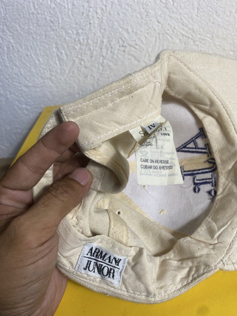 Armani Junior Cream Cap Hat (Category: Caps & Hats) located in Cabanatuan. Submitted by brightwater-2083 (Listing ID 1467315600, Image 3). Description: - Brand: Armani Junior - Color: Cream canvas with blue 'AJr.' embroidered logo - Material: 100% cotton (Manufactured by Simint S.p.A., Made in China) - Fit: Adjustable plastic strap closure at the back - Condition: Excellent, inner care tag attached - Shipping & Meet-ups available across the PH!.