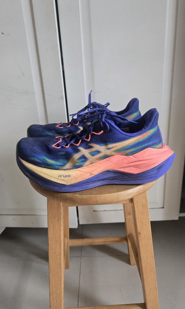 ASICS Super Blast 3 (Category: Sneakers) located in Mandaluyong City. Submitted by ohayouclub (Listing ID 1466993862, Image 3). Description: - Brand: ASICS - Colorway: Deep blue upper with multi-color gradient branding (blue, pink, orange) - Tech: FF Blast+ and FF Leap technology visible on sole and midsole - Condition: Moderate wear on soles, with dirt and scuffing on the green rubber outsole inserts from previous runs - great condition - great 