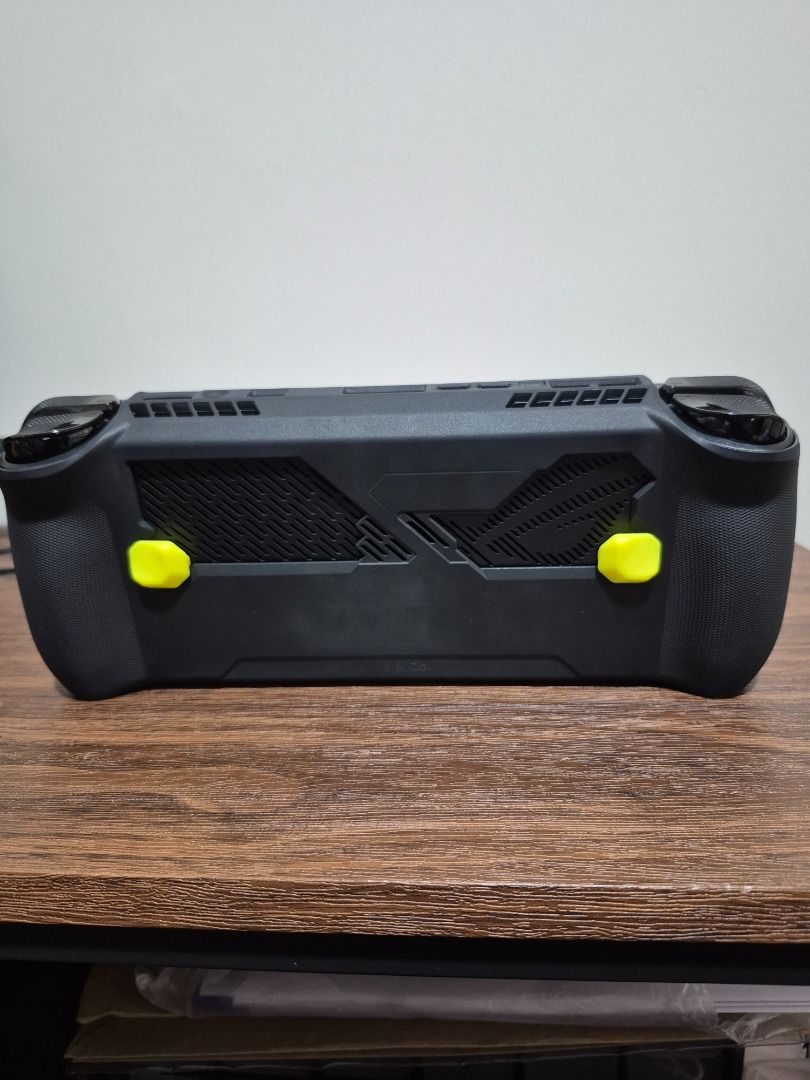 ASUS ROG Ally Z1 Extreme Handheld Console (Category: Nintendo) located in Caloocan City. Submitted by erguizajan68392 (Listing ID 1467180713, Image 2). Description: - Device: ASUS ROG Ally - Processor: AMD Ryzen Z1 Extreme - Memory: 16GB RAM for high frame rates and smooth gameplay - Accessories: Fitted black rubber grip case with custom yellow back buttons - Condition/Display: Screen shows a clear display with active library interface - Deal: RF