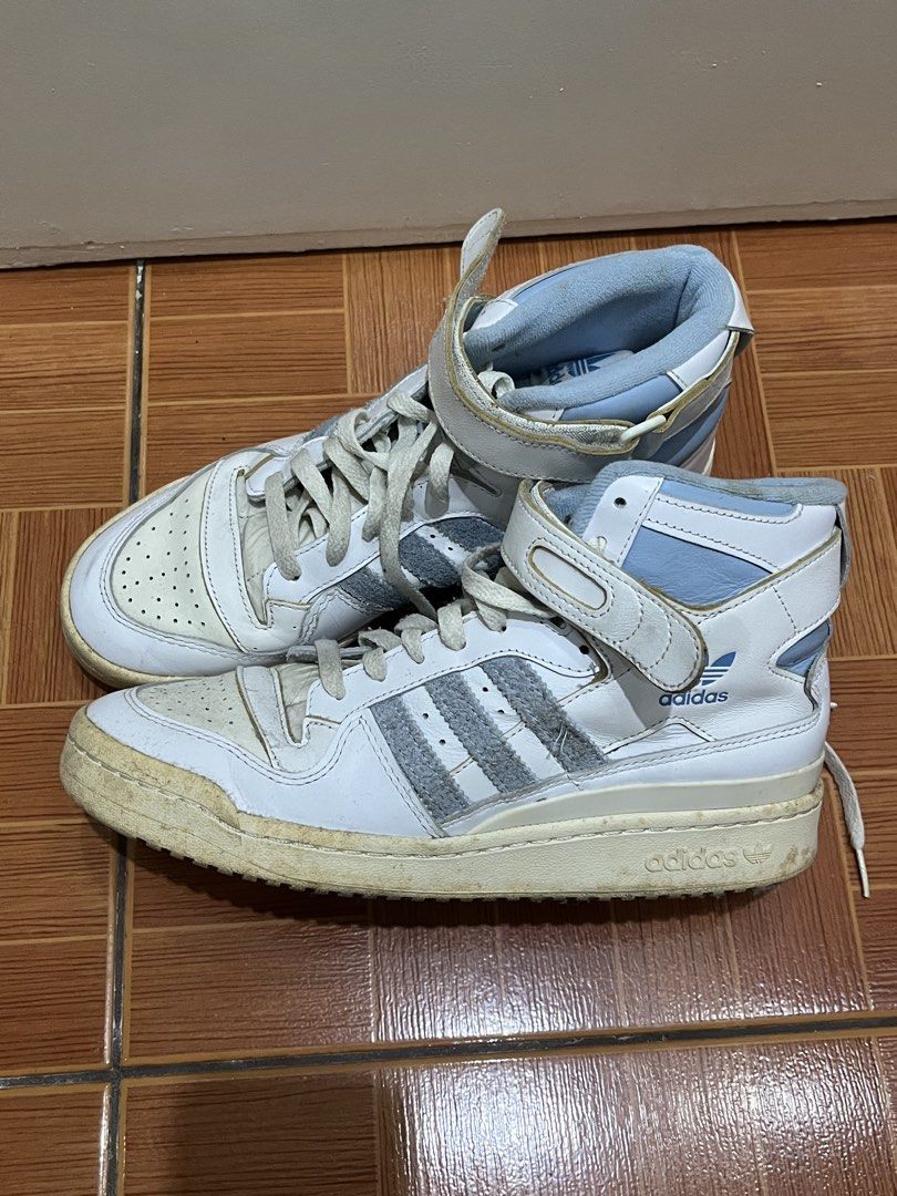 AUTHENTIC / ORIGINAL Adidas Forum Mid White Light Blue Sneakers (Category: Sneakers) located in Paranaque City. Submitted by strangers.things (Listing ID 1467313484, Image 1). Description: - Brand: Adidas Forum Mid - Color: White and Light Blue - Size: US 9 / UK 8.5 / EU 42 2/3 - Design: High-top with adjustable ankle straps, suede three stripes, and perforated toe box - Condition: Needs cleaning - Style: Perfect everyday streetwear kicks.
