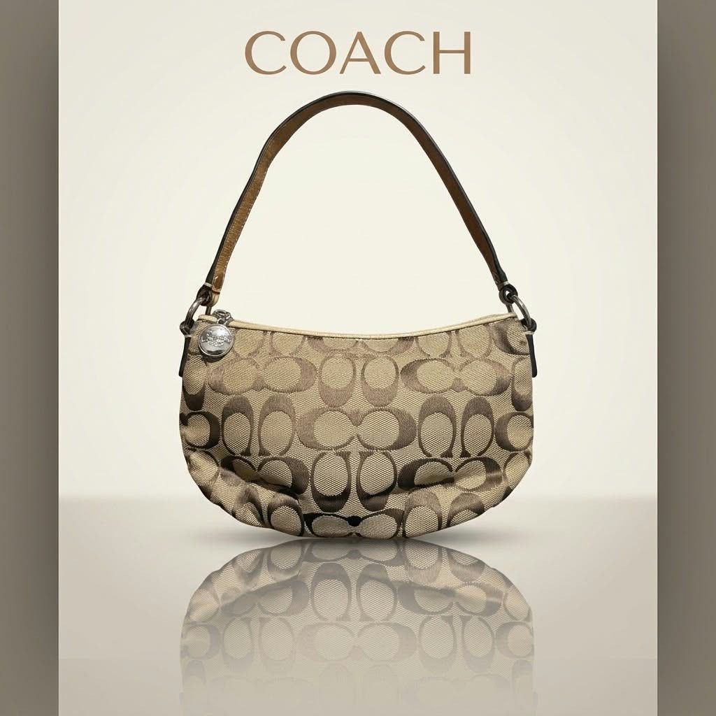 Authentic Coach Signature C Canvas Small Shoulder Bag (Category: Luxury Bags & Wallets) located in Carmen. Submitted by rr_thrifts (Listing ID 1467289294, Image 1). Description: - Authentic Coach signature C canvas shoulder bag in classic brown and tan - Matching leather strap, trim, and iconic Coach hangtag charm included - Secure zipper closure with polished silver-tone hardware - Compact design, perfect for carrying your daily essentials - Ext