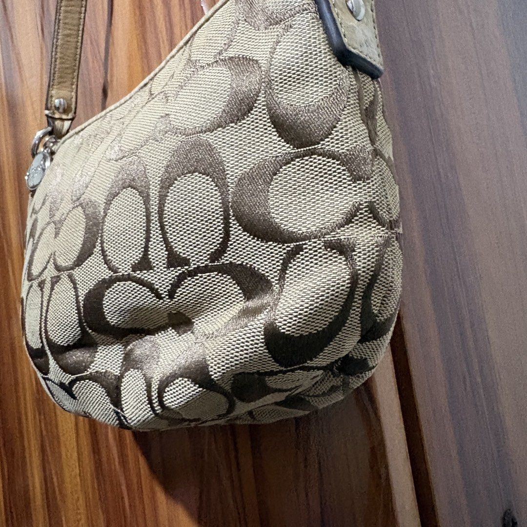 Authentic Coach Signature C Canvas Small Shoulder Bag (Category: Luxury Bags & Wallets) located in Carmen. Submitted by rr_thrifts (Listing ID 1467289294, Image 3). Description: - Authentic Coach signature C canvas shoulder bag in classic brown and tan - Matching leather strap, trim, and iconic Coach hangtag charm included - Secure zipper closure with polished silver-tone hardware - Compact design, perfect for carrying your daily essentials - Ext