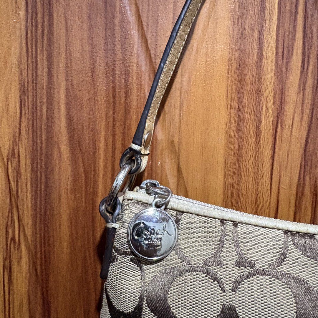 Authentic Coach Signature C Canvas Small Shoulder Bag (Category: Luxury Bags & Wallets) located in Carmen. Submitted by rr_thrifts (Listing ID 1467289294, Image 2). Description: - Authentic Coach signature C canvas shoulder bag in classic brown and tan - Matching leather strap, trim, and iconic Coach hangtag charm included - Secure zipper closure with polished silver-tone hardware - Compact design, perfect for carrying your daily essentials - Ext
