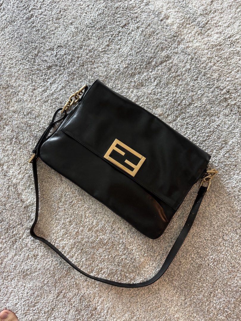 Authentic Fendi Black Leather Baguette (Category: Luxury Bags & Wallets) located in Makati City. Submitted by markussangabriel (Listing ID 1467240160, Image 1). Description: - Brand: Fendi - Color: Black with gold-tone hardware - Design: Classic FF logo plaque on front flap closure - Strap: Adjustable leather and chain strap - Interior: Dark grey fabric lining with a zipper pocket - Condition: Clean exterior and interior - Style: Timeless, versat
