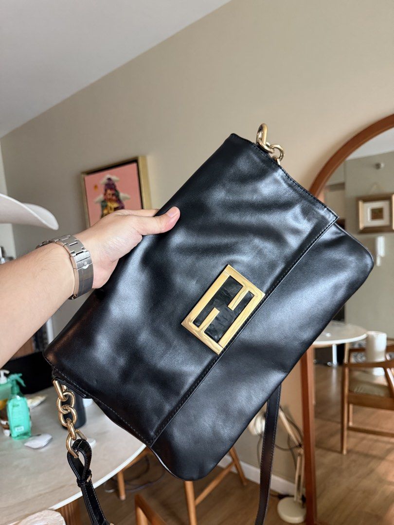 Authentic Fendi Black Leather Baguette (Category: Luxury Bags & Wallets) located in Makati City. Submitted by markussangabriel (Listing ID 1467240160, Image 3). Description: - Brand: Fendi - Color: Black with gold-tone hardware - Design: Classic FF logo plaque on front flap closure - Strap: Adjustable leather and chain strap - Interior: Dark grey fabric lining with a zipper pocket - Condition: Clean exterior and interior - Style: Timeless, versat