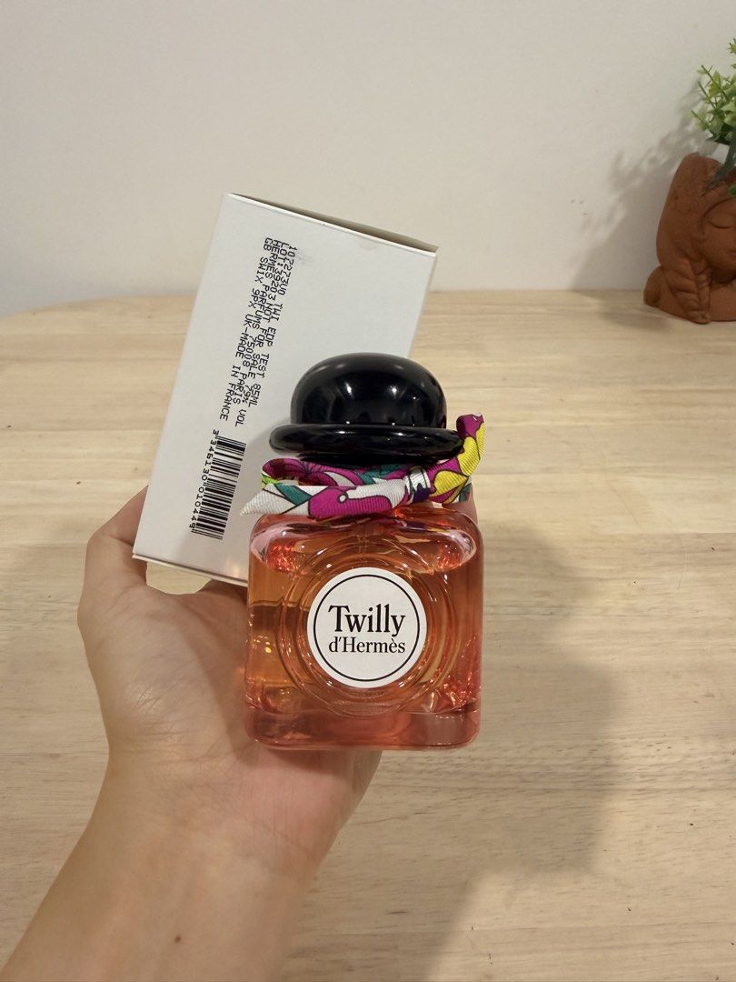 Authentic Hermès Twilly d'Hermès Eau de Parfum 85ml (Tester) (Category: Fragrance & Deodorants) located in Rizal. Submitted by ecrystalsph (Listing ID 1467362036, Image 1). Description: - Brand: Hermès - Item: Twilly d'Hermès Perfume (Tester) - Volume: 85ml - Packaging: Includes original white box with barcode and batch details - Design: Clear glass bottle with orange juice, iconic black cap, and colorful silk ribbon - Best for: Daily signature s