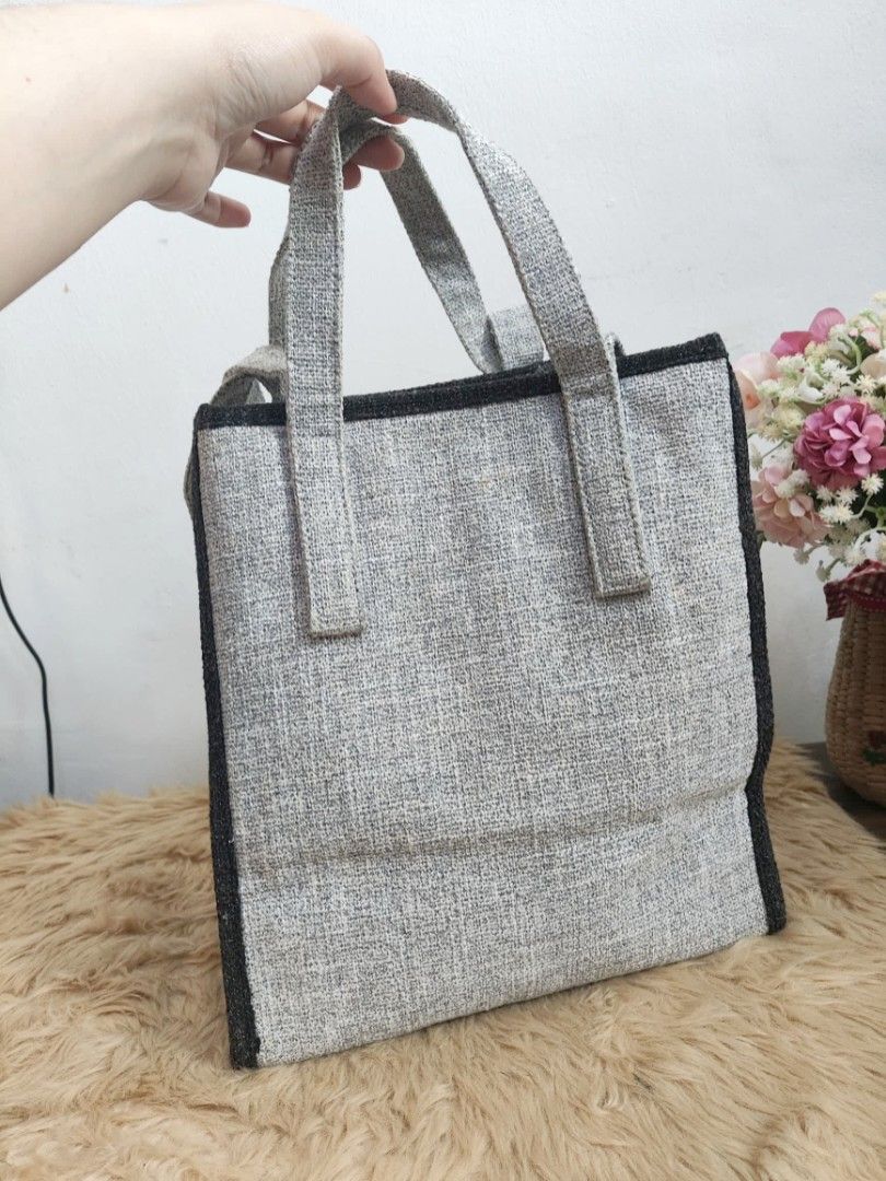 Authentic Joy Gryson unisex shoppers tote bag (Category: Tote Bags) located in Rizal. Submitted by hsiri1128 (Listing ID 1467168166, Image 2). Description: 💯✔️Legit CONDITION : 8.5/10 ISSUE / FLAWS : Needs minimal cleaning MATERIAL : Thick canvas, parang marhen J ang material DETAILS : Medium size, spacious inside. stand alone with stabilizer. fit ipad and folding umbrella.