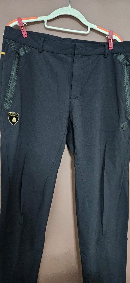 Automobili Lamborghini x Descente Black Pants (Category: Joggers) located in Santa Maria. Submitted by rommelmateo (Listing ID 1467351882, Image 1). Description: - Authentic Automobili Lamborghini x Descente collaborative pants - Sleek solid black colorway with a clean overall shape - Features special logo patches on the front pocket and back waist - Equipped with secure zippered pockets and textured detailing - Made from lightweight, breathable 