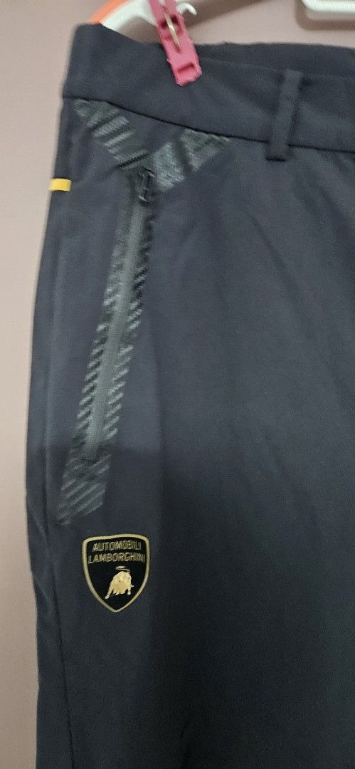 Automobili Lamborghini x Descente Black Pants (Category: Joggers) located in Santa Maria. Submitted by rommelmateo (Listing ID 1467351882, Image 3). Description: - Authentic Automobili Lamborghini x Descente collaborative pants - Sleek solid black colorway with a clean overall shape - Features special logo patches on the front pocket and back waist - Equipped with secure zippered pockets and textured detailing - Made from lightweight, breathable 