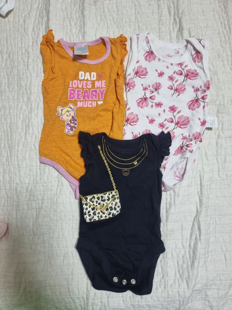 Baby Girl Bodysuits 3-6 Months Bundle Set (Category: Babies & Kids Fashion) located in Narvacan. Submitted by 2ndchancefinder (Listing ID 1467294734, Image 1). Description: - Size: 3-6 months - Material: 100% breathable cotton - Condition: Gently used, excellent quality - Quantity: Bundle of 3 adorable bodysuits - Design 1: White with sweet pink flower prints - Design 2: Black with printed necklace, handbag graphic, and bottom snap buttons - Desi