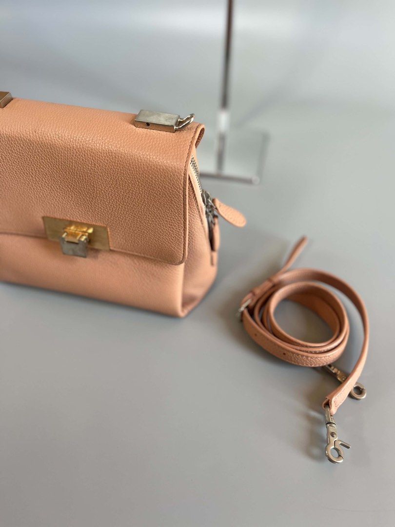 Balenciaga le dix authentic (Category: Luxury Bags & Wallets) located in Tacloban City. Submitted by luxbag_phhh (Listing ID 1467182793, Image 3). Description: Authentic balenciaga le dix pink pebbled leather shoulder bag. Features gold and silver twist lock hardware, detachable strap, and clean interior with a zip pocket. Includes authentication card. Perfect compact size for everyday use! Missing strap handle bilhan nyo nlang pero jan pa sling 