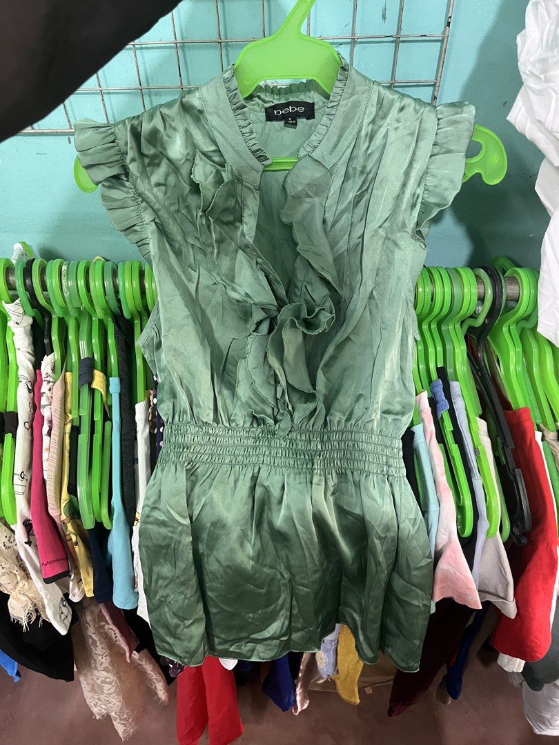 bebe Green Ruffle Sleeveless Blouse Size S (Category: Sleeveless) located in Dagupan City. Submitted by shanadongsb (Listing ID 1467351619, Image 1). Description: - Brand: bebe - Size: Small - Color: Sage green with a subtle satin sheen - Style: Sleeveless with dramatic front ruffles and stand collar - Fit: Smocked elastic waist for a flattering, fitted silhouette - Condition: Excellent / Pre-loved - Perfect for work, dates, or special occasions.