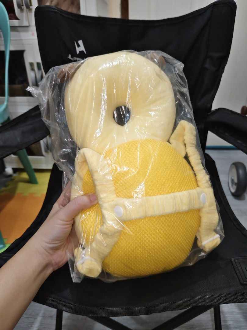 Bee Anti-Fall Baby Head Protection Backpack Pillow (Category: Babies & Kids Fashion) located in Pasay City. Submitted by jynrn24 (Listing ID 1467236648, Image 2). Description: - Adorable yellow and brown bee design - Backpack style with secure padded shoulder straps - Soft plush material with cute white wings and head cushion support - Protects baby's head during falls - Brand new and still sealed in clear plastic packaging.