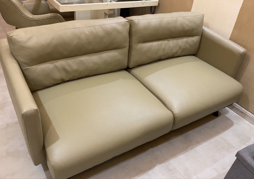beige 2-seater leather sofa couch (Category: Sofas) located in Manila. Submitted by 3_co.ph (Listing ID 1467344448, Image 2). Description: - Type: 2-seater sofa - Color: Neutral beige - Material: Smooth leather with sturdy dark legs - Design: Clean lines, simple modern style - Comfort: Firm and comfortable cushions - Ideal For: Small living rooms, apartments, or offices.