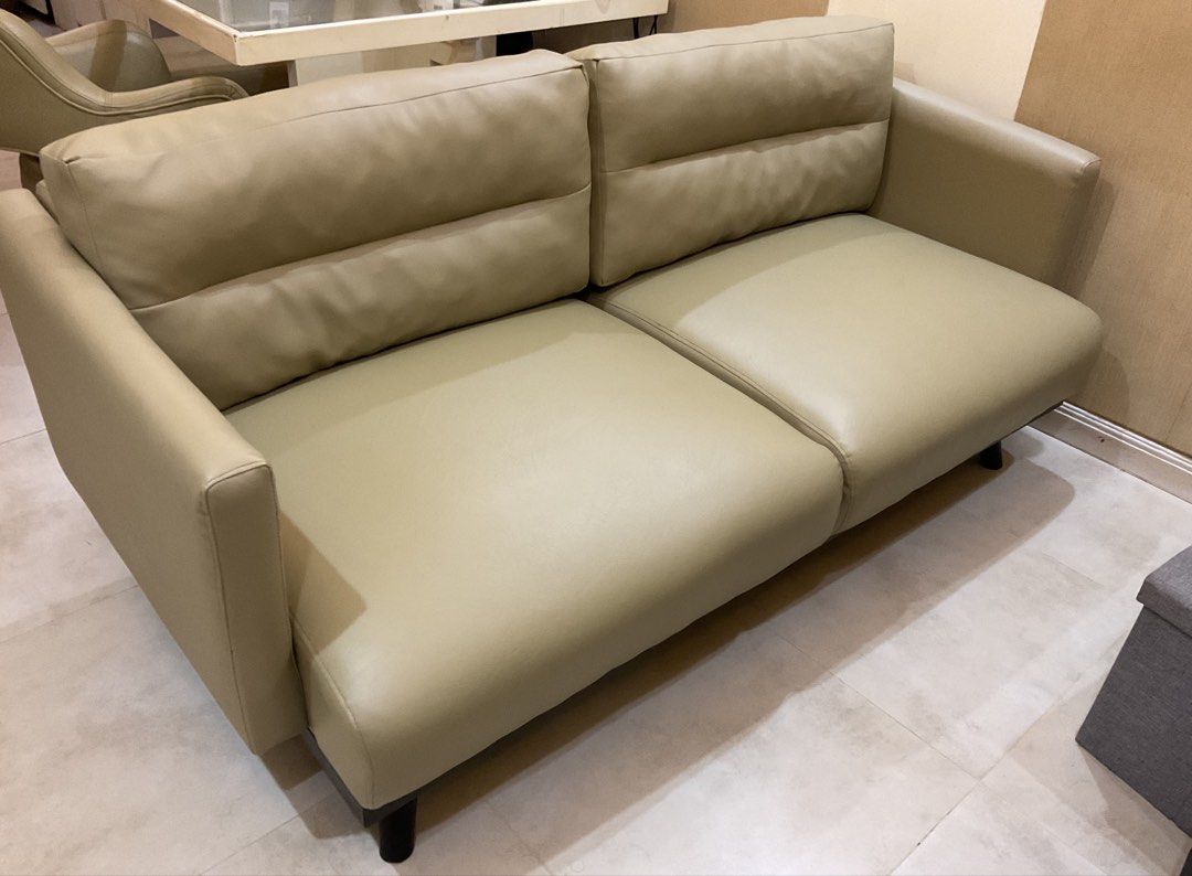 beige 2-seater leather sofa couch (Category: Sofas) located in Manila. Submitted by 3_co.ph (Listing ID 1467344448, Image 3). Description: - Type: 2-seater sofa - Color: Neutral beige - Material: Smooth leather with sturdy dark legs - Design: Clean lines, simple modern style - Comfort: Firm and comfortable cushions - Ideal For: Small living rooms, apartments, or offices.