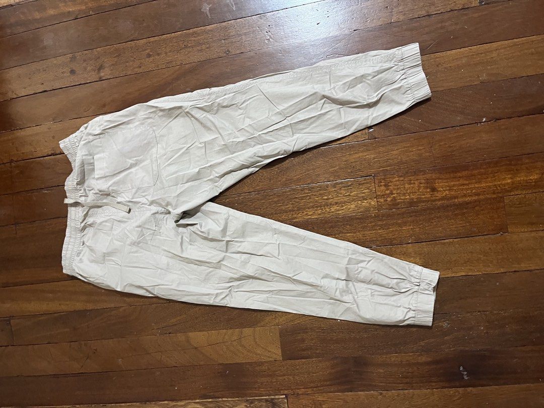 Beige Jogger Pants Drawstring Cuffs (Category: Joggers) located in Quezon City. Submitted by silverriver_3cf939 (Listing ID 1467230968, Image 2). Description: - Color: Beige - Material: Lightweight cotton blend - Waist: Elastic with matching drawstring - Ankles: Cuffed bottom - Pockets: Single back pocket on the right - Condition: Brand new, slightly wrinkled from storage Can fit small since stretchable.