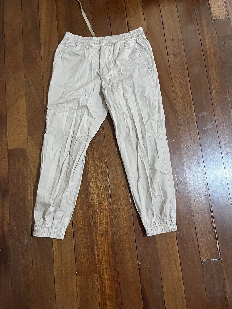 Beige Jogger Pants Drawstring Cuffs (Category: Joggers) located in Quezon City. Submitted by silverriver_3cf939 (Listing ID 1467230968, Image 1). Description: - Color: Beige - Material: Lightweight cotton blend - Waist: Elastic with matching drawstring - Ankles: Cuffed bottom - Pockets: Single back pocket on the right - Condition: Brand new, slightly wrinkled from storage Can fit small since stretchable.
