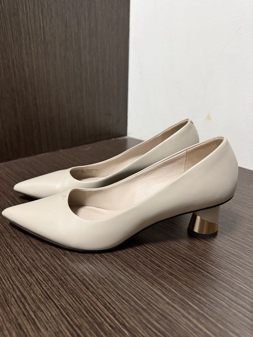 Beige Pointed Toe Pumps with Metallic Block Heels (Category: Heels) located in Mandaluyong City. Submitted by aradoria (Listing ID 1467204268, Image 1). Description: - Color: Clean neutral beige - Design: Slip-on pointed toe with minimalist styling - Heel: Comfortable chunky block heel featuring a distinctive metallic gold accent - Versatility: Perfect for office wear, corporate attire, and formal events.