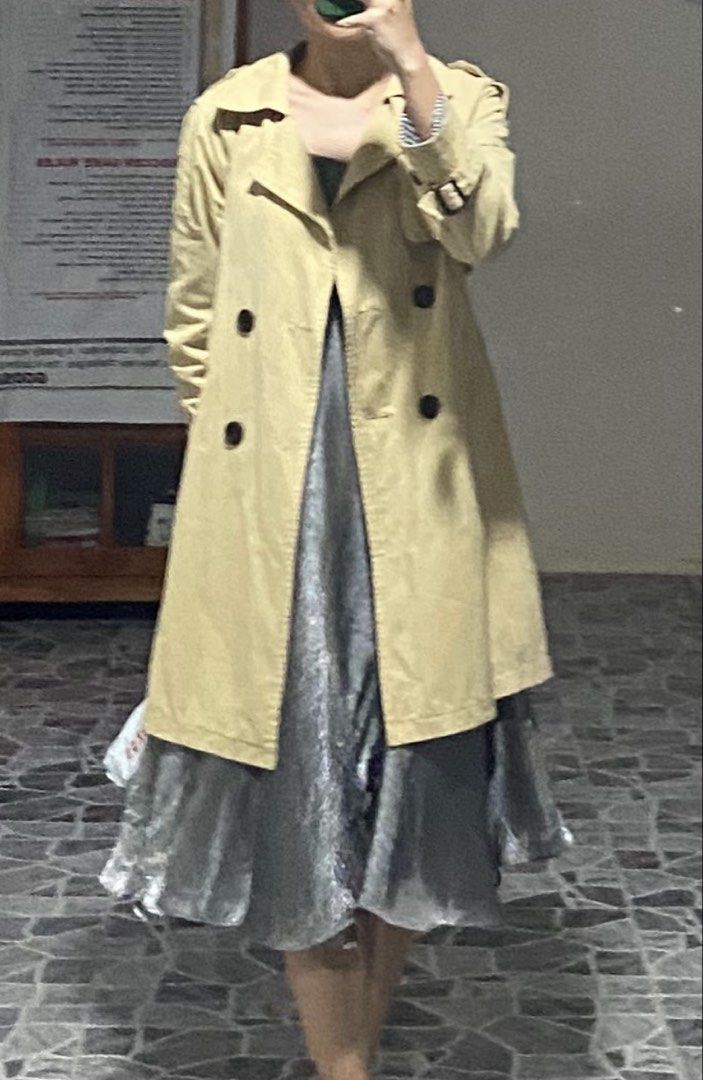 Beige Trench Coat with Black Striped Lining (Category: Coats, Jackets and Outerwear) located in Ozamiz City. Submitted by icadls (Listing ID 1467122375, Image 1). Description: - Classic beige trench coat with a chic double-breasted button front - Includes a matching waist belt for an adjustable, flattering fit - Eye-catching black and white vertical striped lining on the interior, cuffs, and lapel underside - Structured collar, shoulder epaulets,
