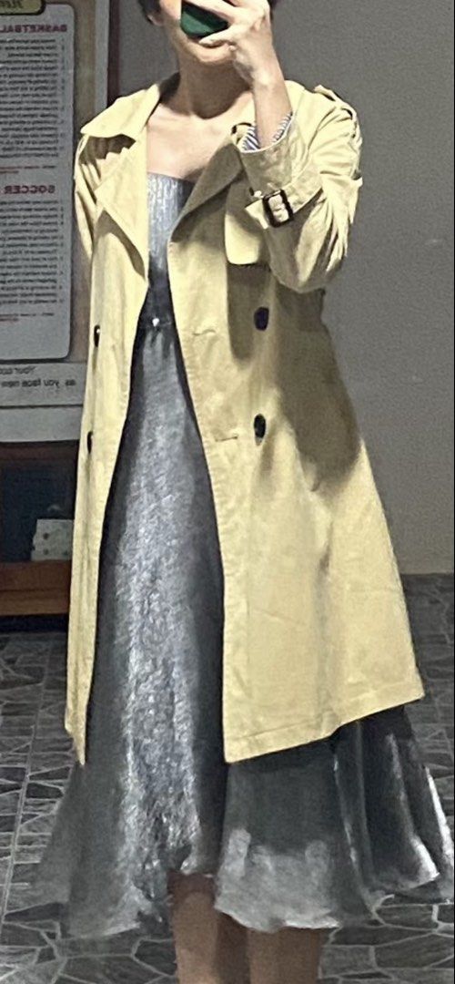 Beige Trench Coat with Black Striped Lining (Category: Coats, Jackets and Outerwear) located in Ozamiz City. Submitted by icadls (Listing ID 1467122375, Image 2). Description: - Classic beige trench coat with a chic double-breasted button front - Includes a matching waist belt for an adjustable, flattering fit - Eye-catching black and white vertical striped lining on the interior, cuffs, and lapel underside - Structured collar, shoulder epaulets,