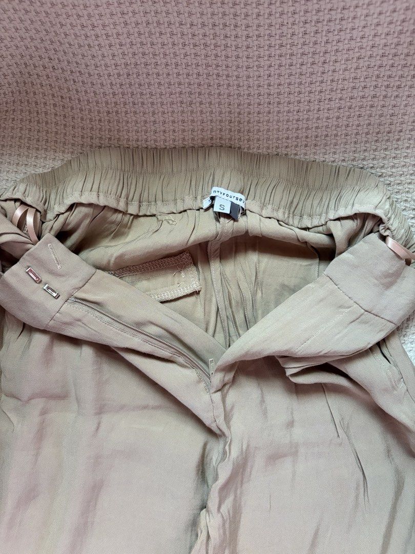 Beige Trousers Size S (Category: Other Bottoms) located in Manila. Submitted by amilannnn (Listing ID 1467198182, Image 2). Description: - Brand: niftyfourtwenty - Size: S - Color: Beige - Fit: Relaxed straight leg - Waistband: Elastic at the back with front zipper and hook-and-eye closure - Fabric: Light and breathable, perfect for casual days or office wear - Condition: Barely worn, excellent shape - Lightweight and comfortable.