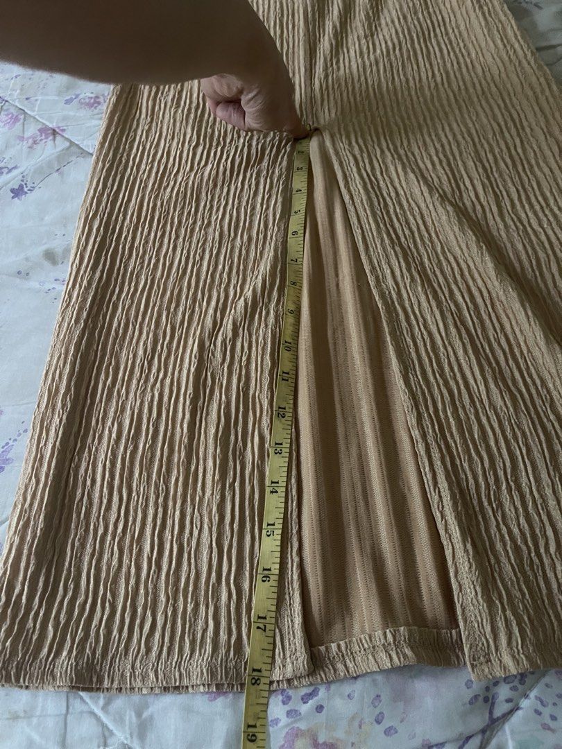 Beige Tube Dress (Category: Dresses) located in Santa Cruz. Submitted by lilpurpleseven (Listing ID 1467177889, Image 3). Description: - Color: Chic beige - Style: Strapless midi tube dress with slip-on fit - Fabric: Fully ruched, textured, and clean (no flaws) - Details: Side tie at the waist and a 19-inch side slit - Measurements: 43 inches total length, pit-to-pit stretches to about 14 inches.