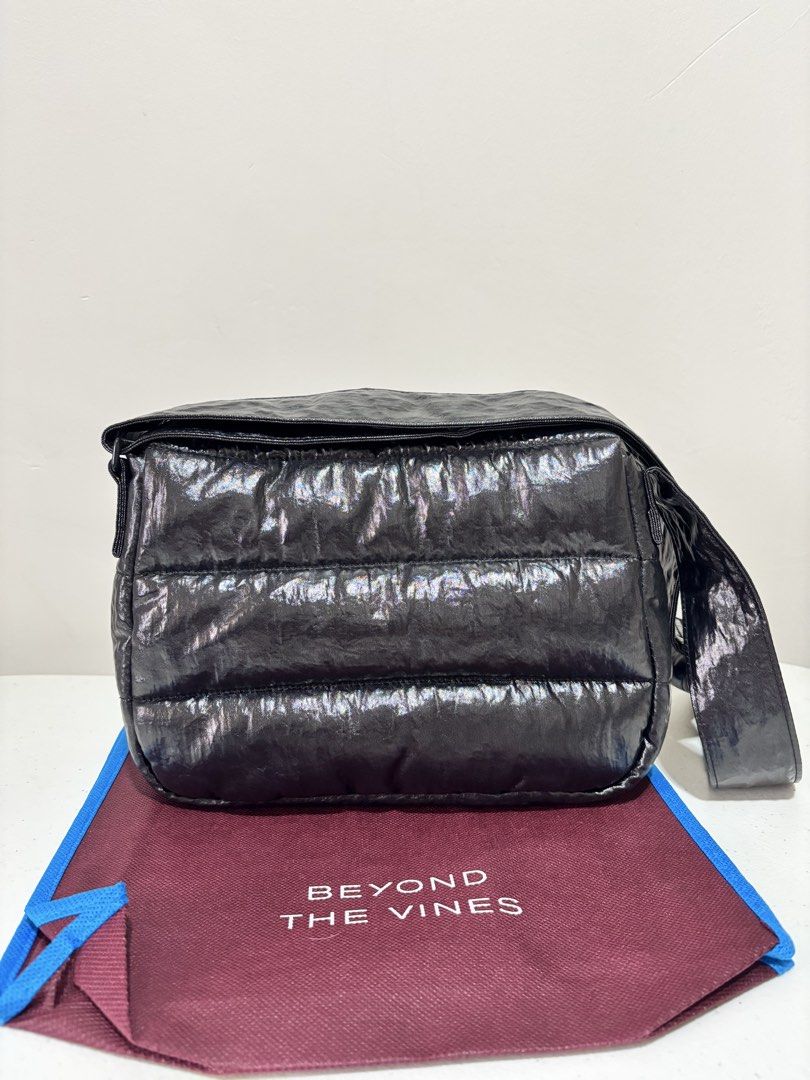 Beyond The Vines Glazed Poofy Bag - Black (Category: Cross-body Bags) located in Taguig. Submitted by yumi9121 (Listing ID 1467290946, Image 2). Description: Like new! 10/10 pristine condition RFS: Rarely used - Original Beyond The Vines Glazed Poofy Bag - Color: Black with contrast blue lining - Material: 100% textured coated nylon - Versatile design: Wear as a shoulder bag or crossbody with adjustable straps - Closure: Front flap with magnetic 